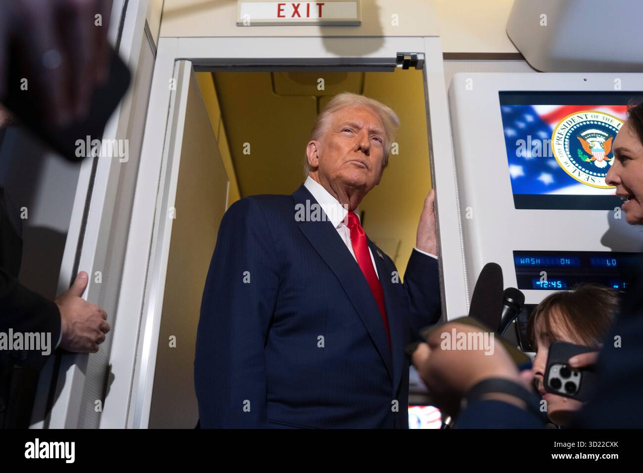 President Donald Trump speaks with reporters aboard Air Force One ...