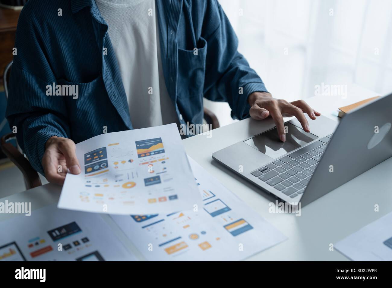 UX UI Designer Planning innovative Mobile App with Paper Wireframe Designs at Workspace. Stock Photo