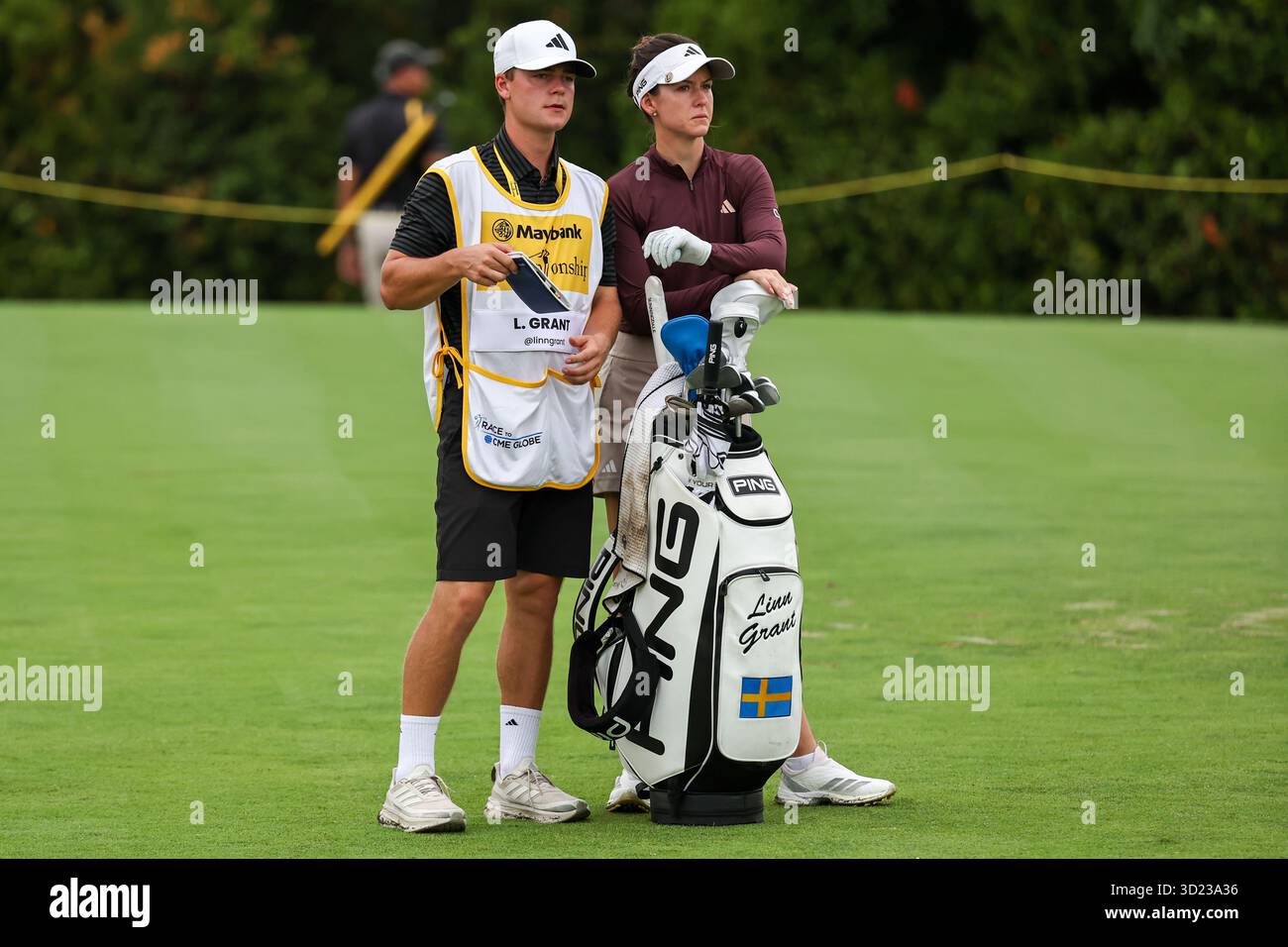 KUALA LUMPUR, - OCTOBER 30: Linn Grant of Sweden with her caddie ...