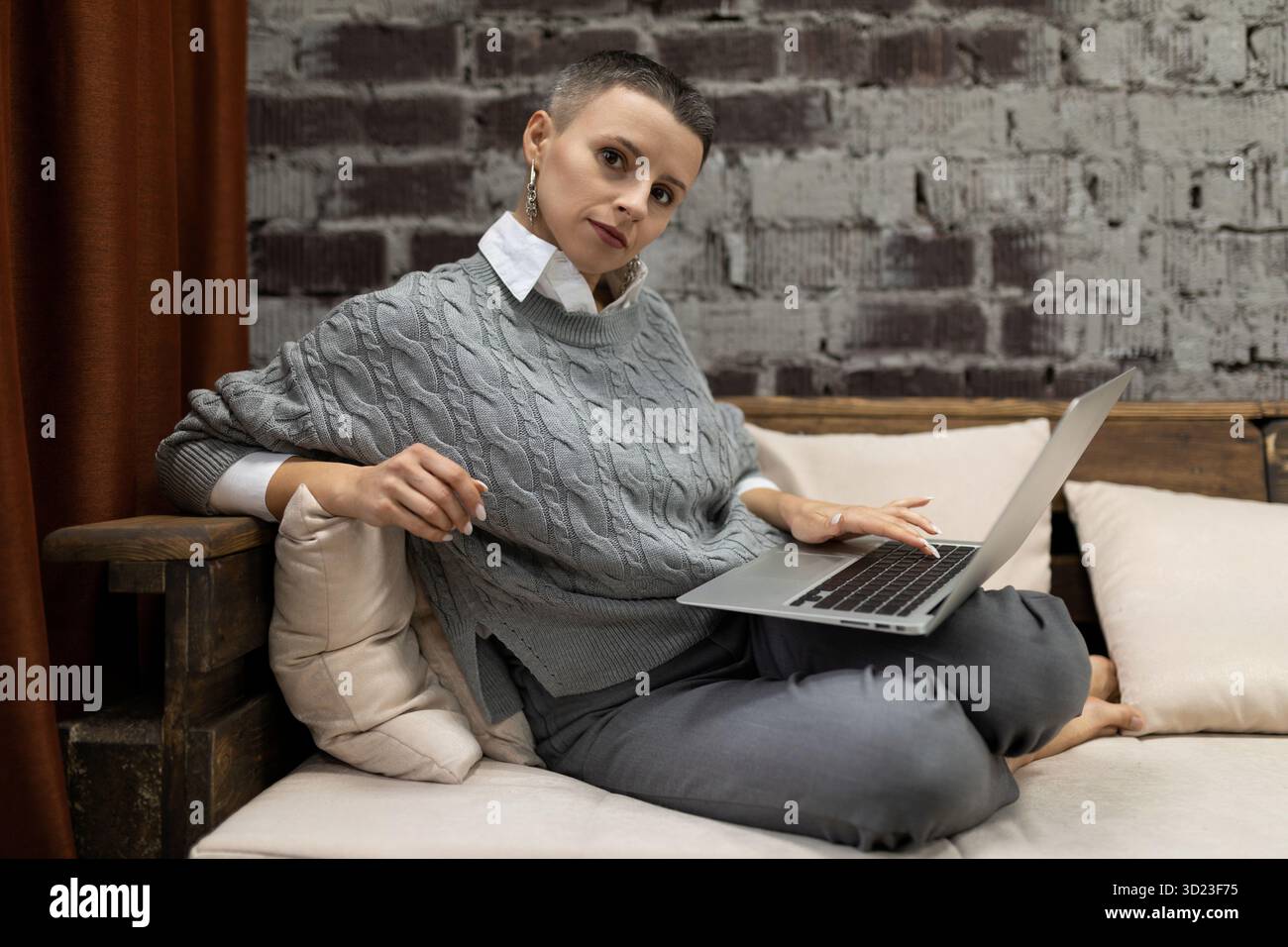 Elegant businesswoman working in the company behind a laptop Stock Photo