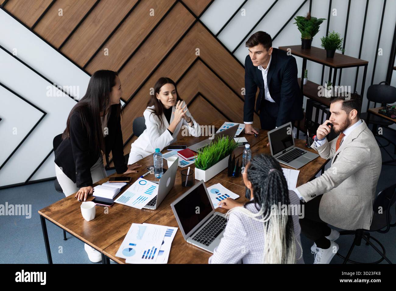 Business meeting in the office on the background of a large table with laptops Stock Photo