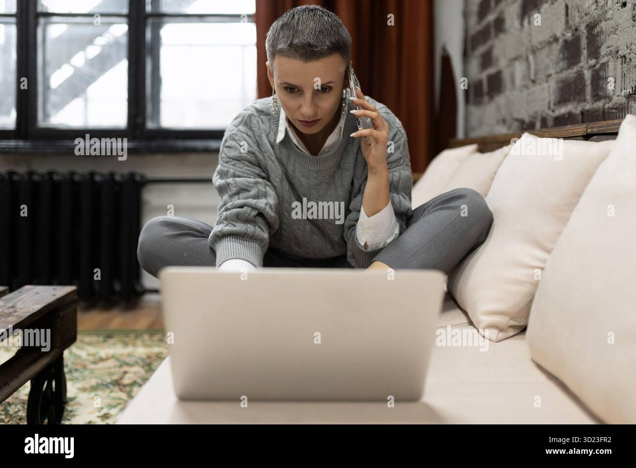 Businesswoman working on startup project sitting with laptop Stock Photo