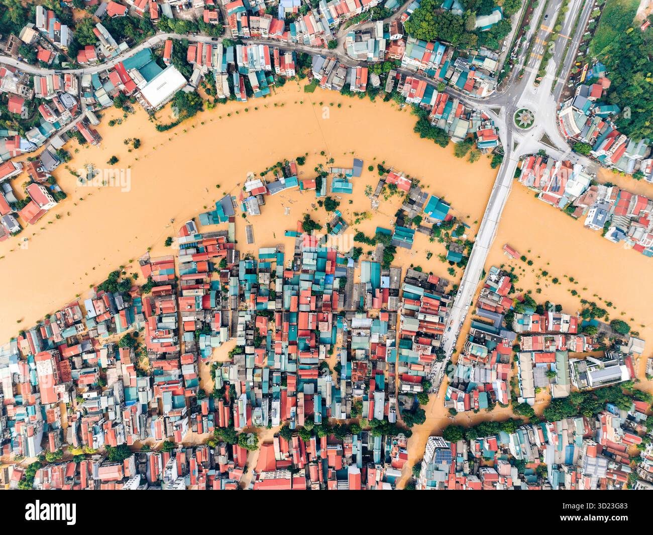 Aerial view of a flooded urban area with colorful rooftops and streets ...