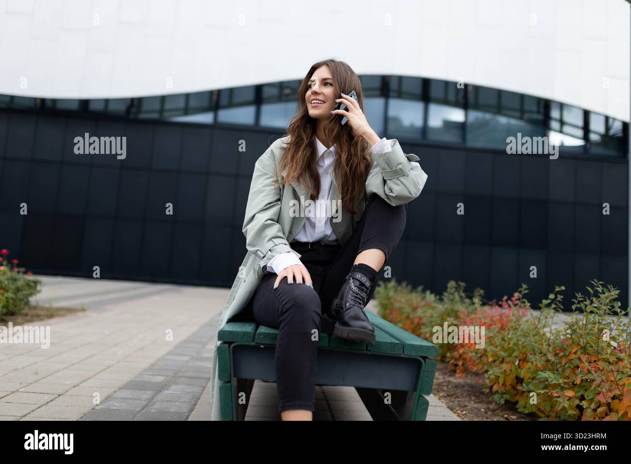 Young female student talking on the phone outside Stock Photo