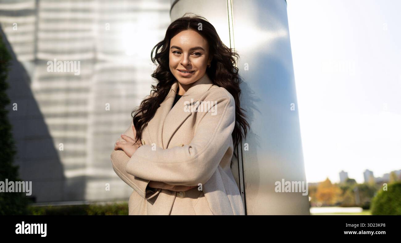 Confident business woman smiling looking at camera outside Stock Photo