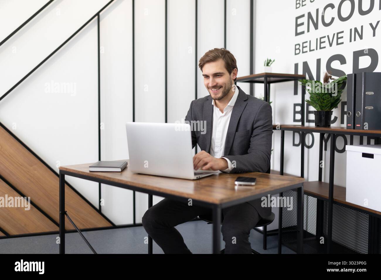 Businessman working on laptop in office Stock Photo