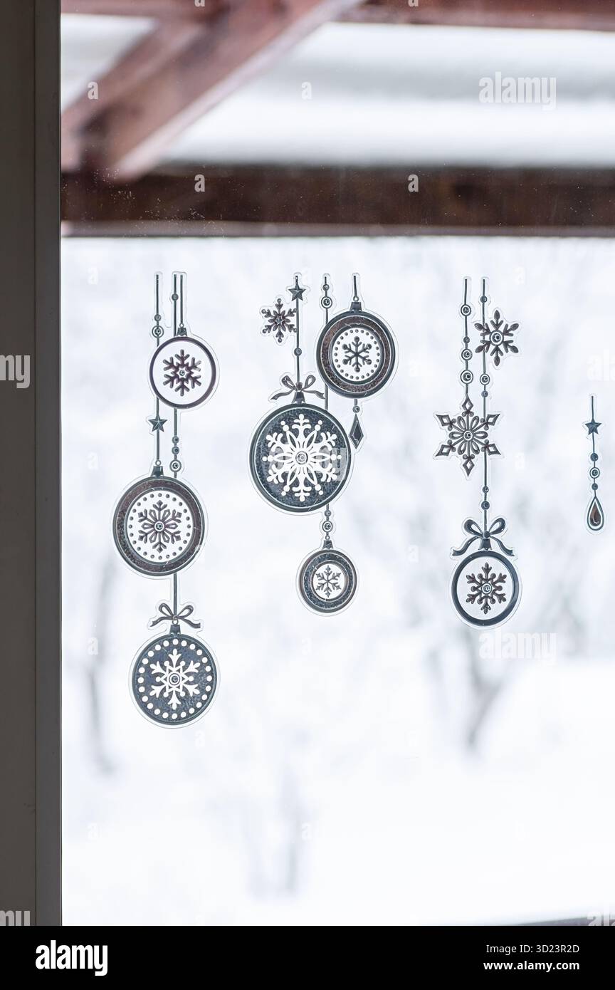 Set of creative Christmas stickers with snowflake ornaments on window glass. Festive winter holiday decoration, transparent modern interior, seasonal Stock Photo