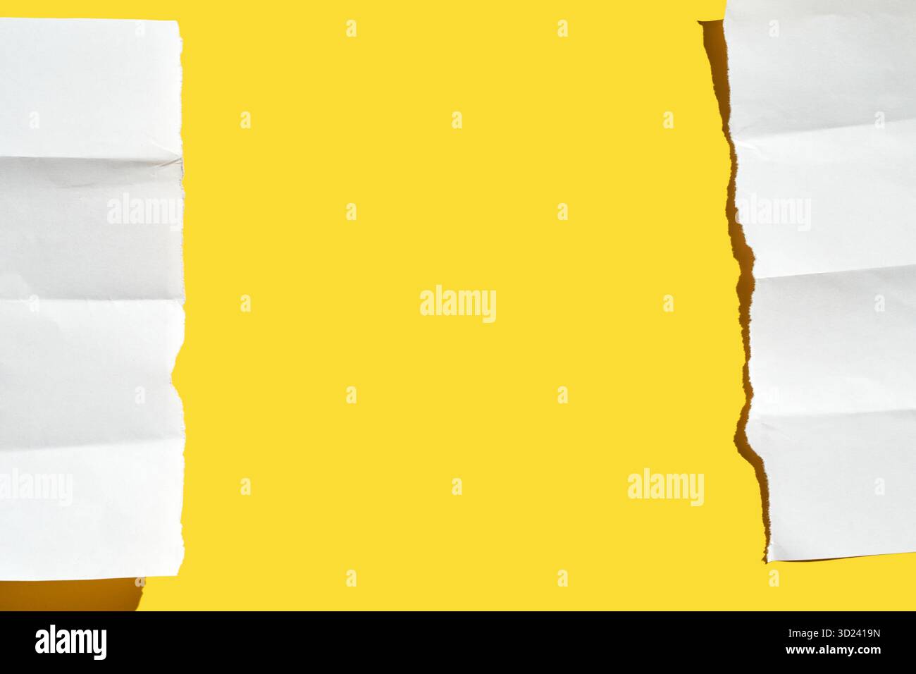 Torn white paper strips on bright yellow background creating contrasting Stock Photo