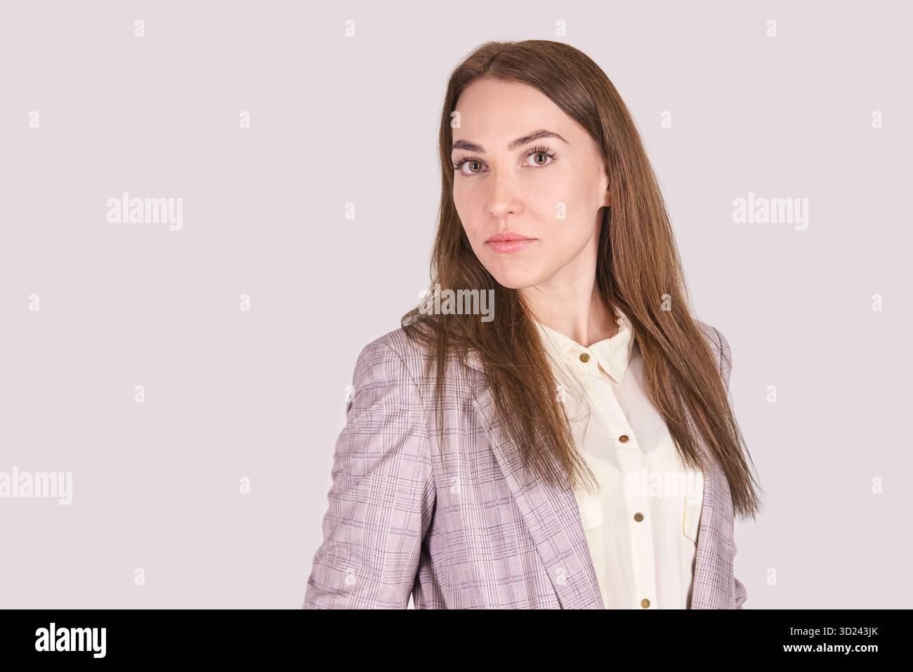 Confident caucasian female professional in plaid blazer with long brown hair Stock Photo