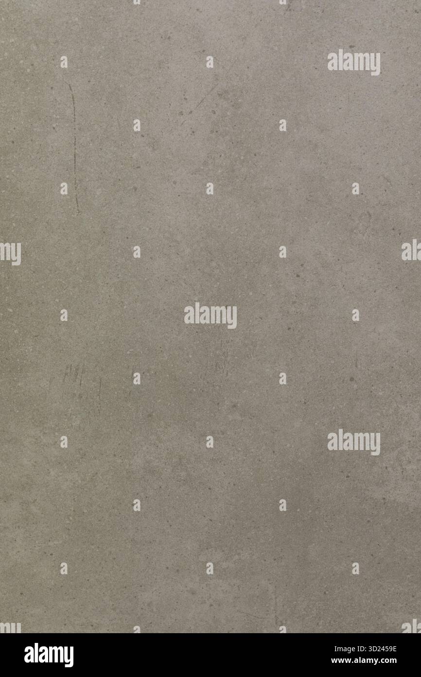 Textured grey wall with subtle variations and light shadows in a minimalist setting Stock Photo