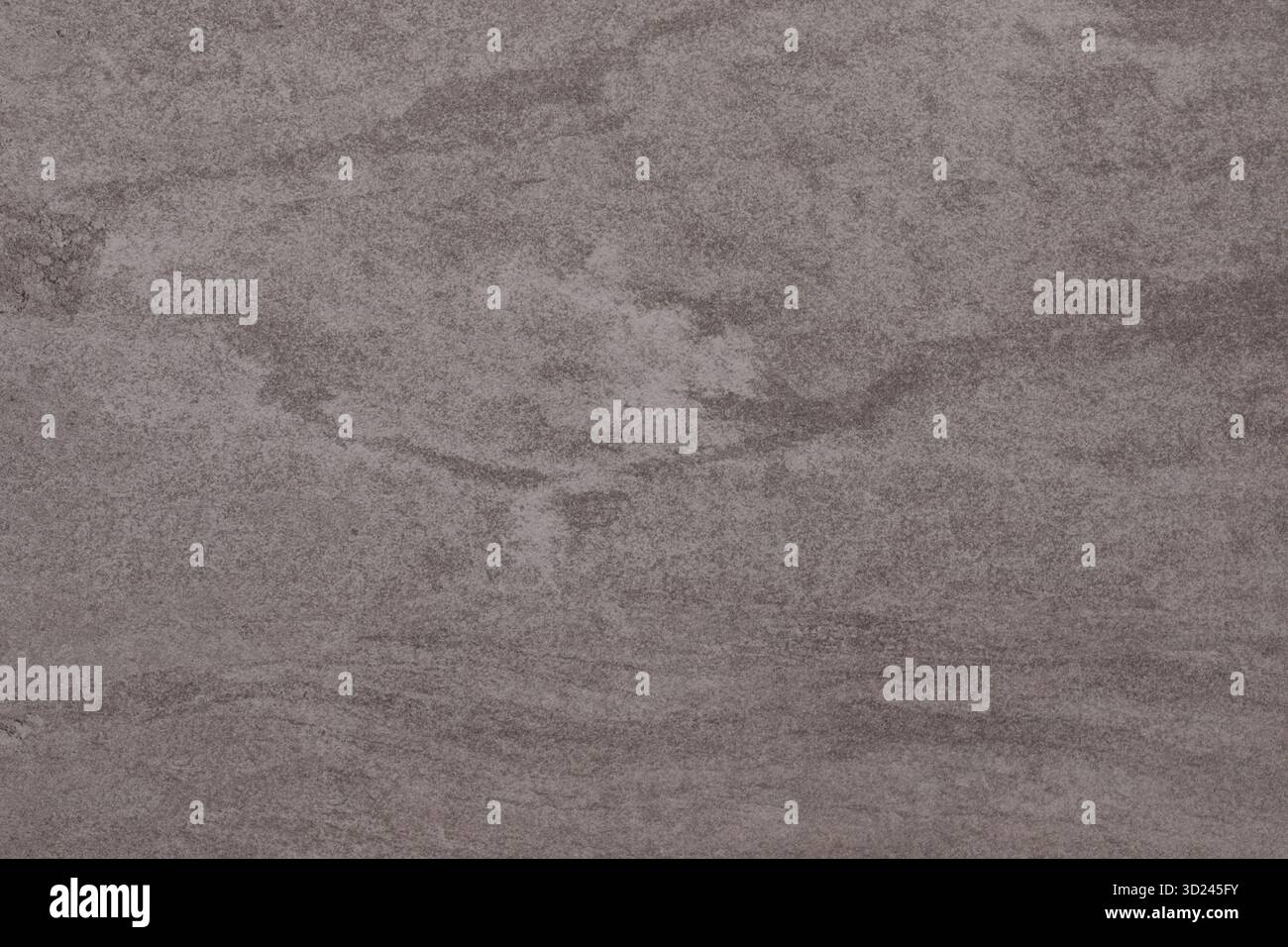 Unique textured surface displaying natural patterns resembling marble from a quarry in late afternoon light Stock Photo