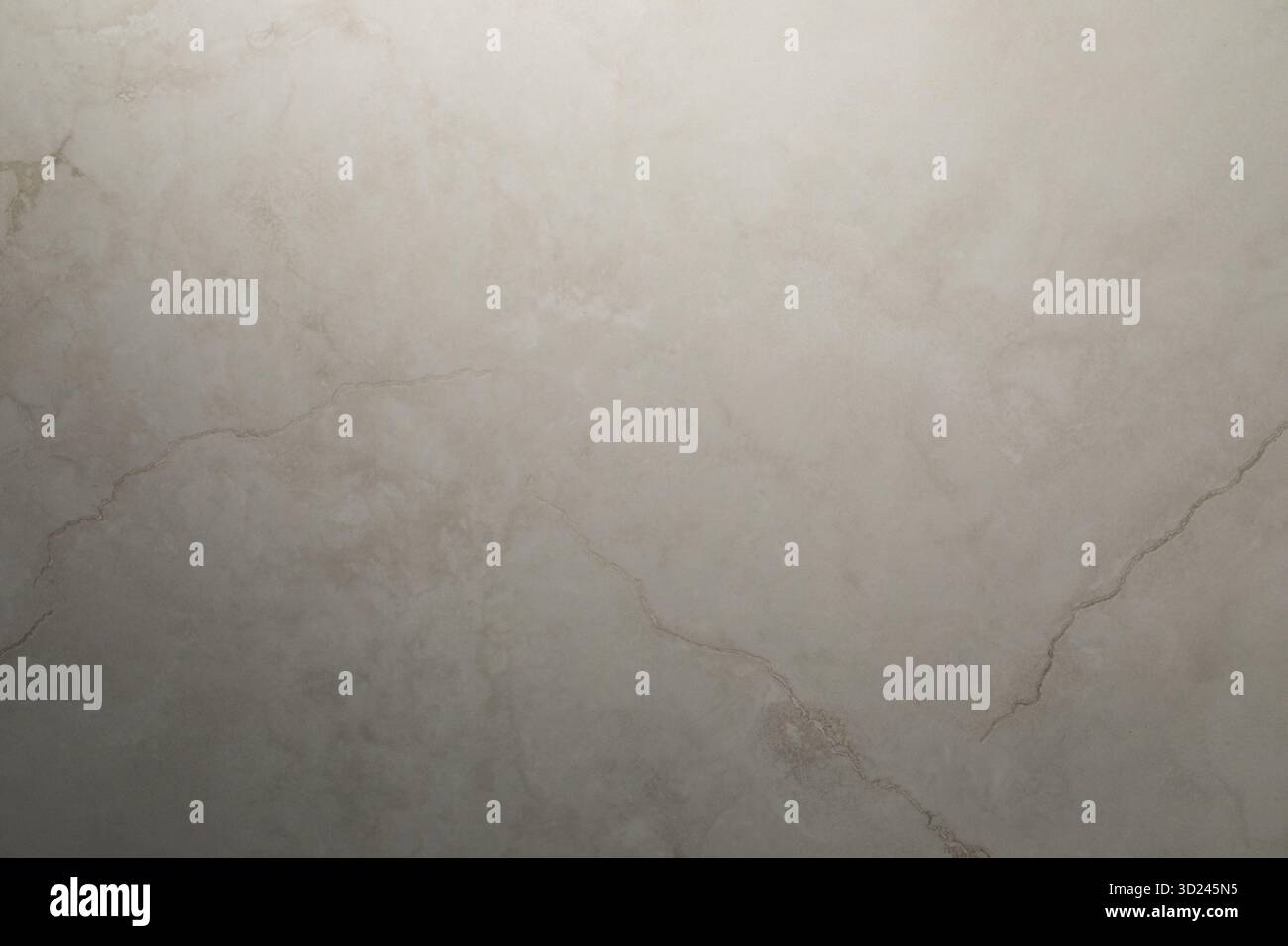 Smooth beige marble surface with subtle texture and veining patterns in natural lighting Stock Photo