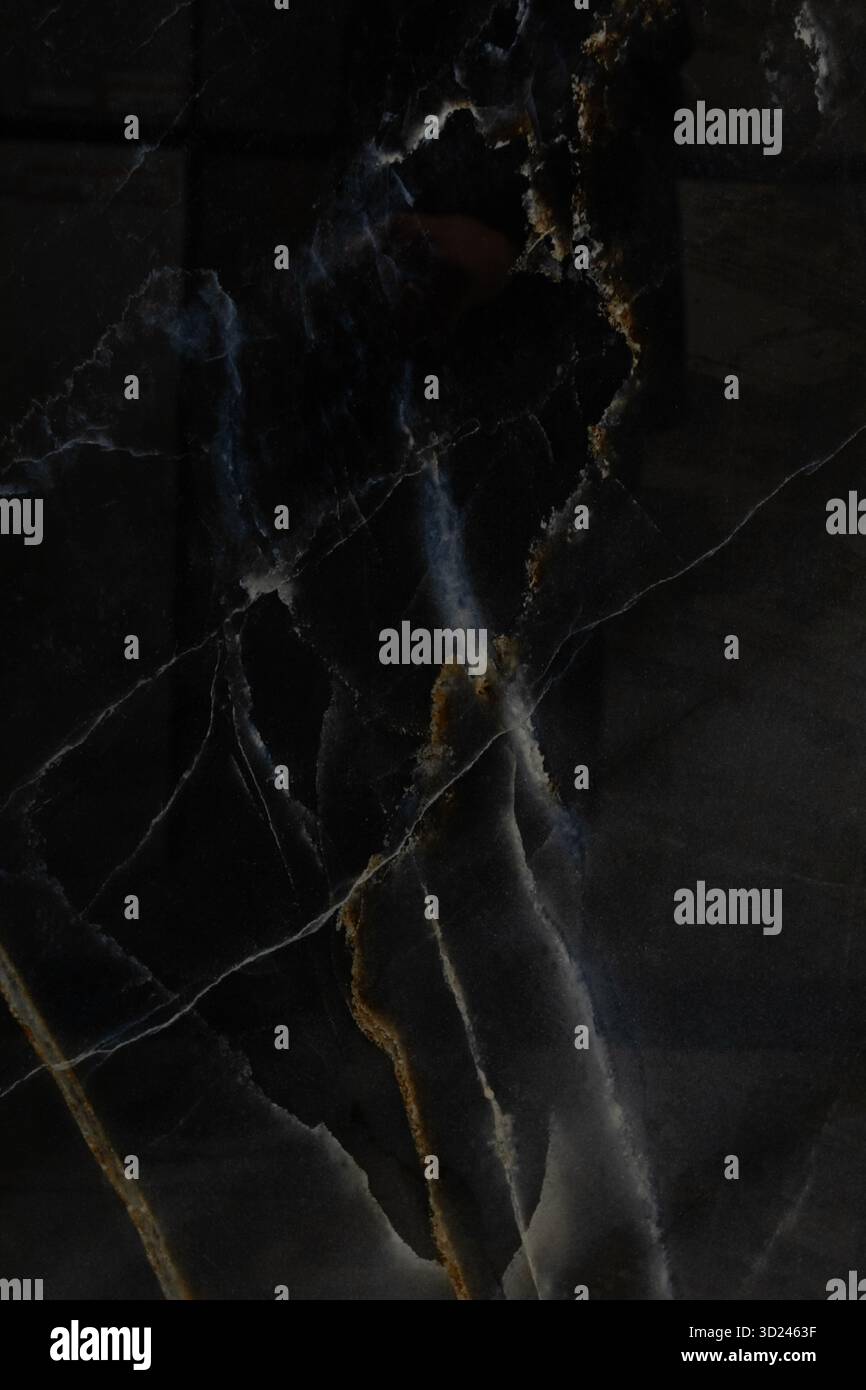 Dark marble surface showcasing intricate patterns and textures in ...
