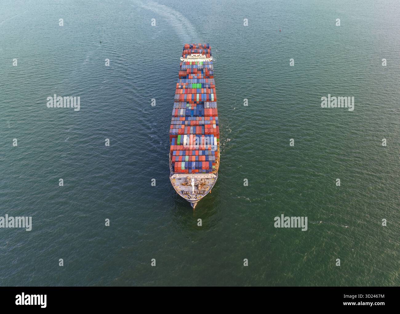 Aerial view of a colossal cargo ship, laden with vibrant containers ...