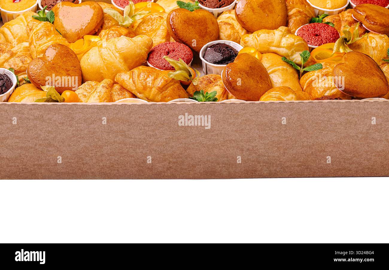 Assorted pastries displayed in a box for a dessert event Stock Photo