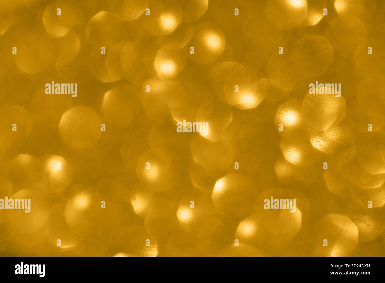Golden bokeh background with soft circular light patterns creating a warm Stock Photo