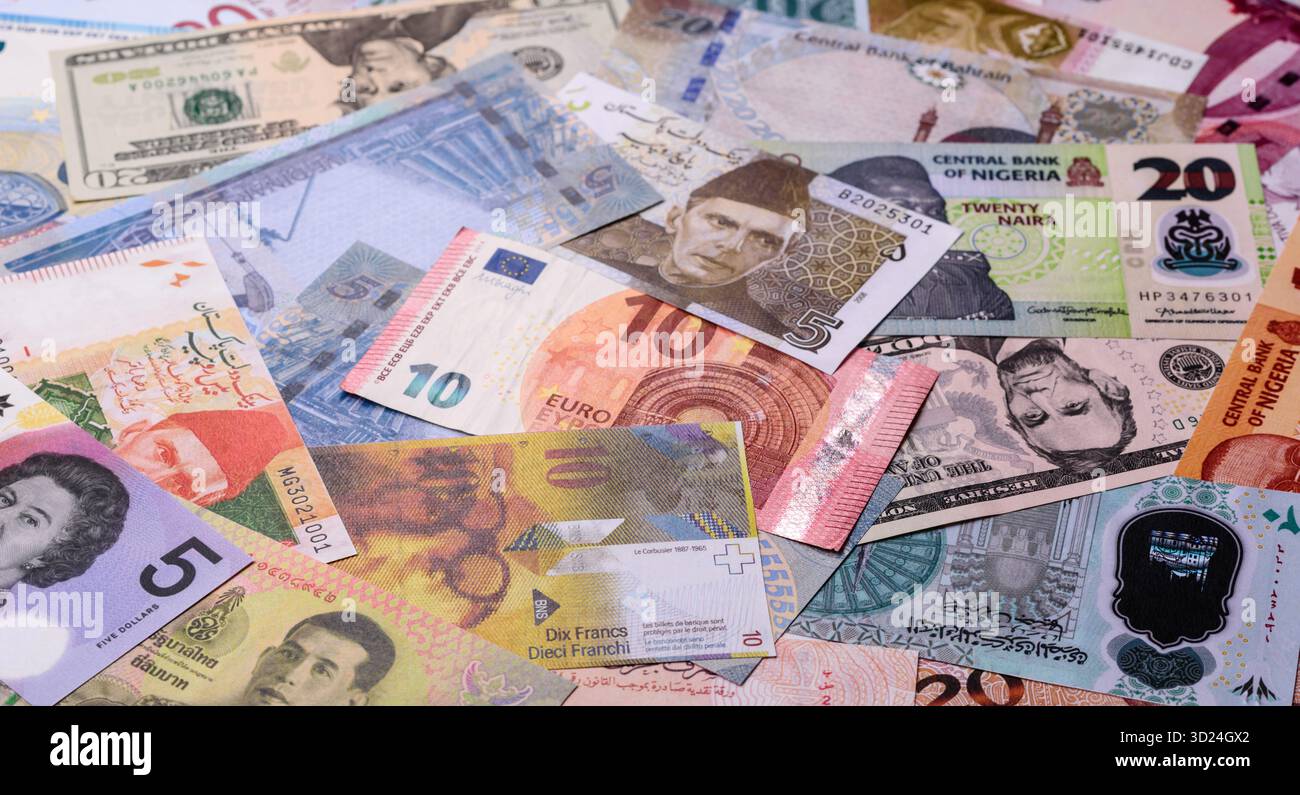 Paper money, banknotes of different countries as a business background. Paper money and cash Stock Photo