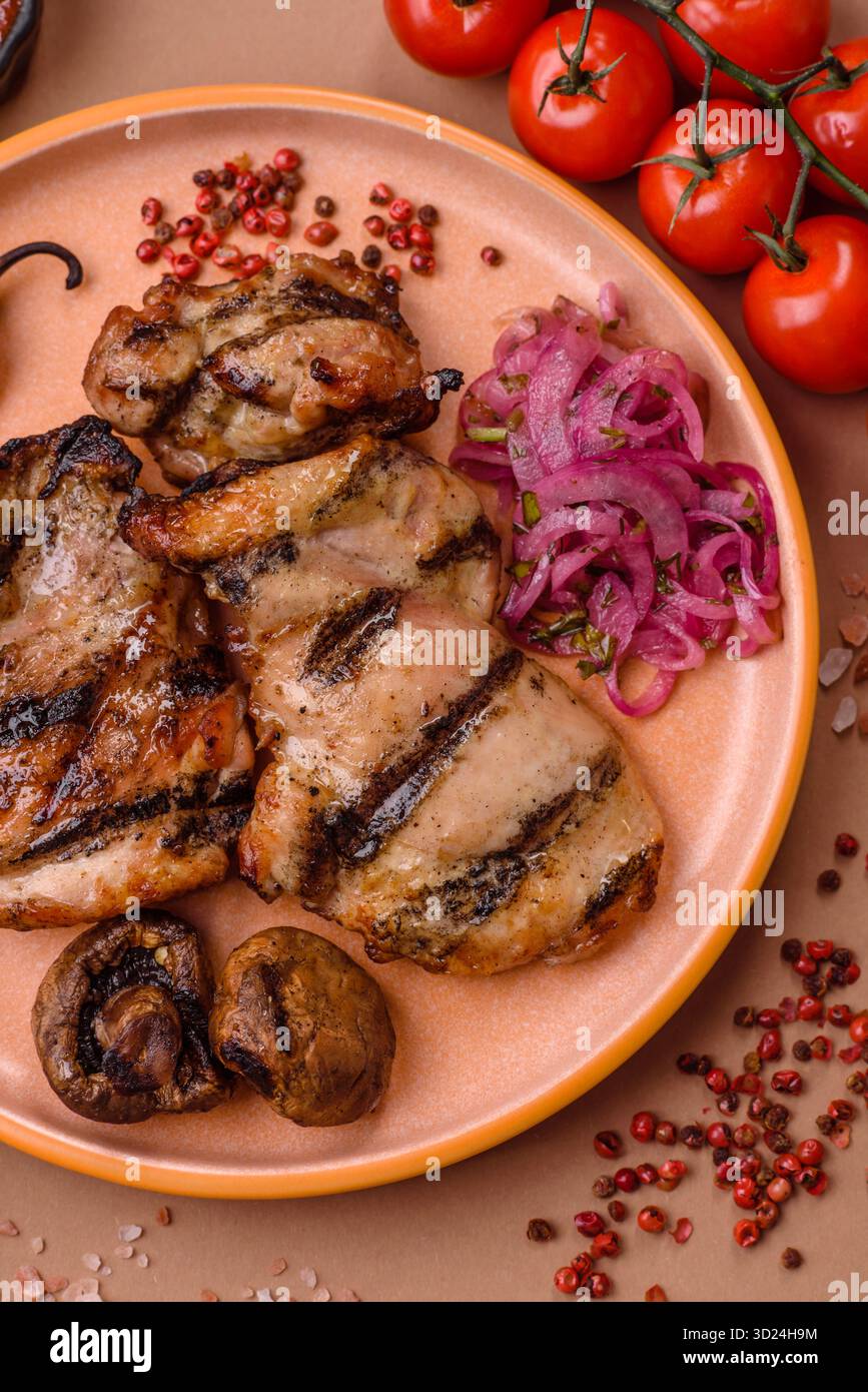 Chicken breast cooked on a grill or barbecue with sauce. Grilled chicken Stock Photo