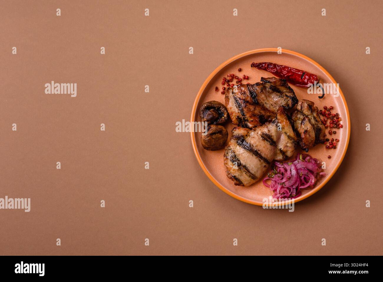 Chicken breast cooked on a grill or barbecue with sauce. Grilled chicken Stock Photo