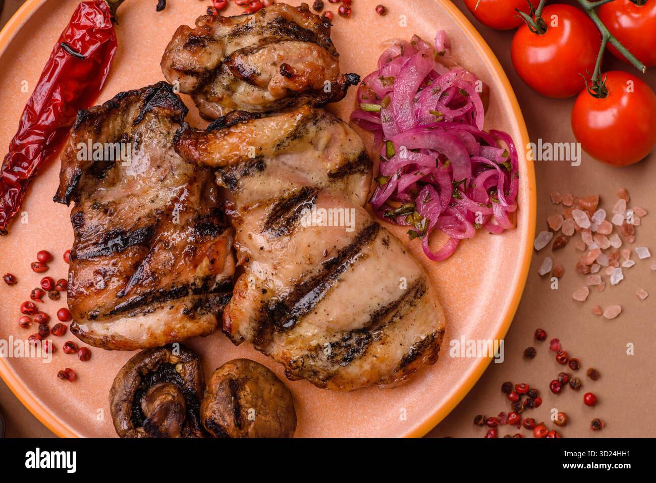 Chicken breast cooked on a grill or barbecue with sauce. Grilled chicken Stock Photo