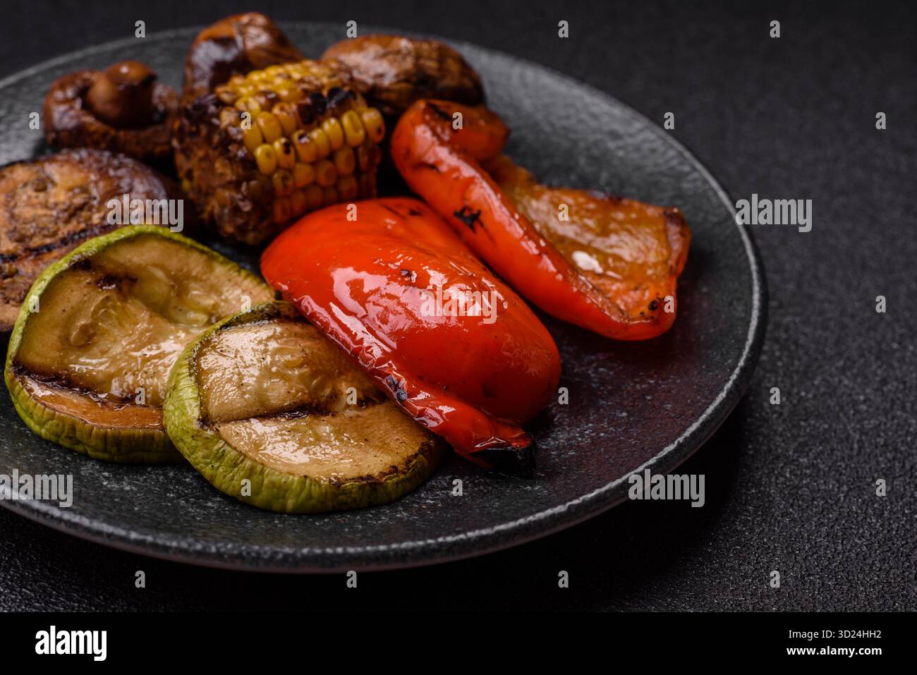 Grilled vegetables, bell peppers, mushrooms, and zucchini, a vegetarian meal. Grilled vegetables Stock Photo