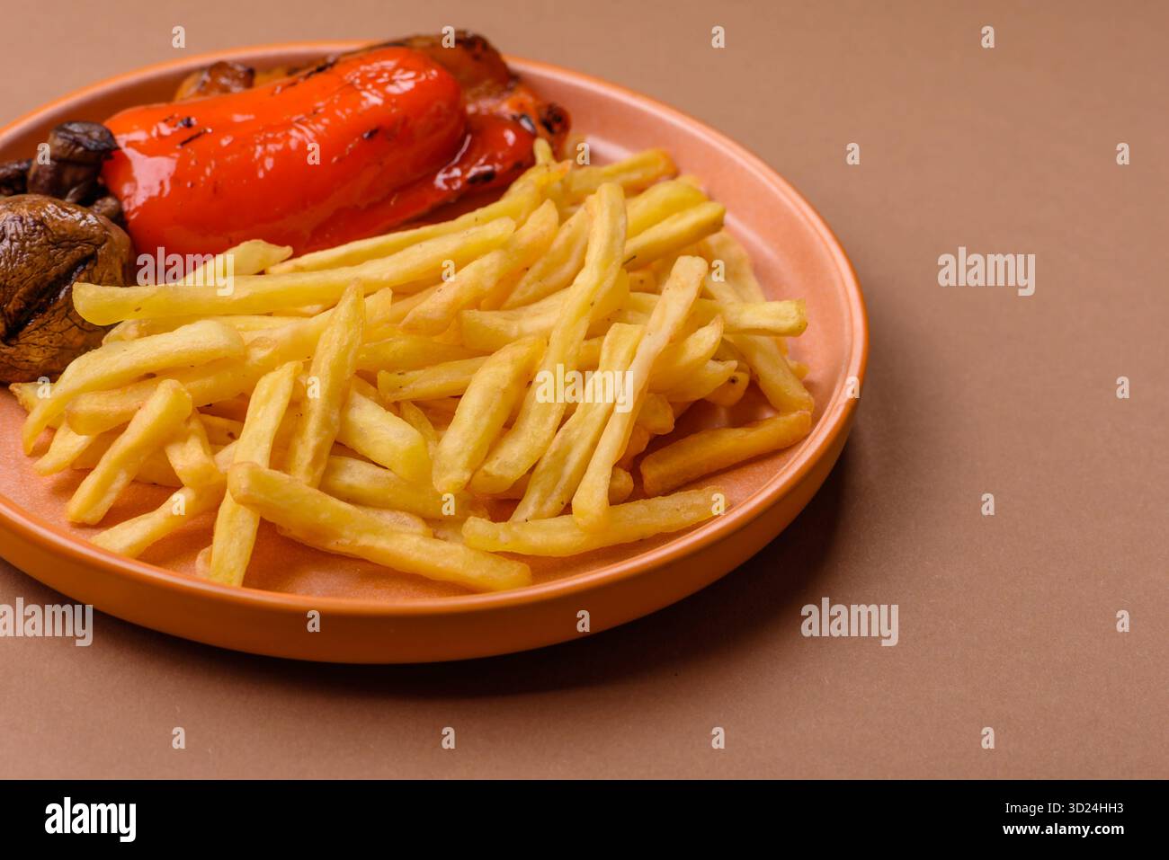 French fries cooked in oil, crispy golden chips, unhealthy food. French fries as a background Stock Photo
