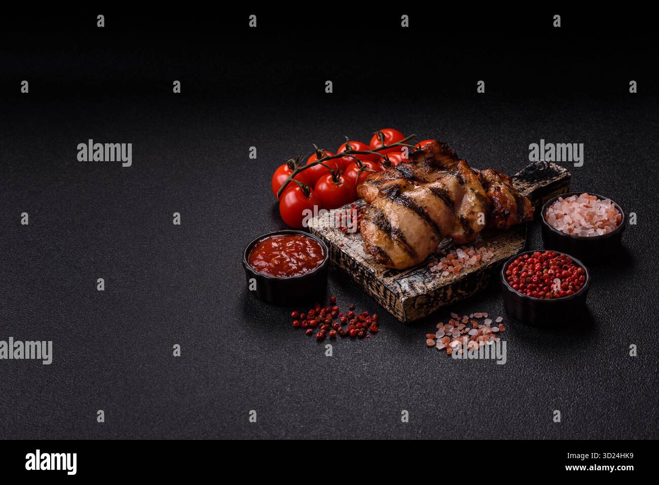 Chicken breast cooked on a grill or barbecue with sauce. Grilled chicken Stock Photo