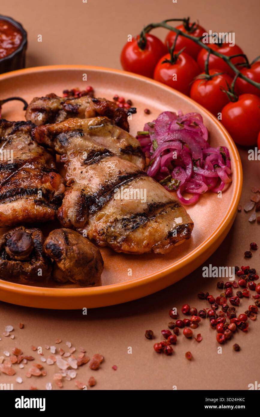 Chicken breast cooked on a grill or barbecue with sauce. Grilled chicken Stock Photo