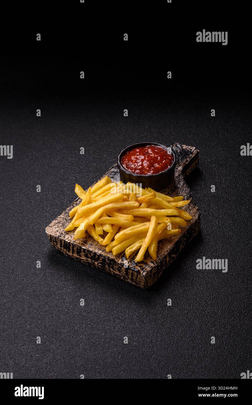 French fries cooked in oil, crispy golden chips, unhealthy food. French fries as a background Stock Photo