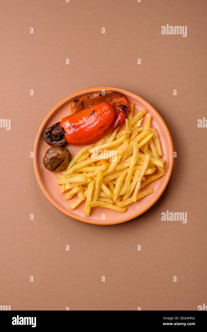 French fries cooked in oil, crispy golden chips, unhealthy food. French fries as a background Stock Photo