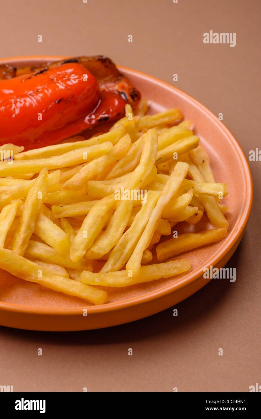 French fries cooked in oil, crispy golden chips, unhealthy food. French fries as a background Stock Photo