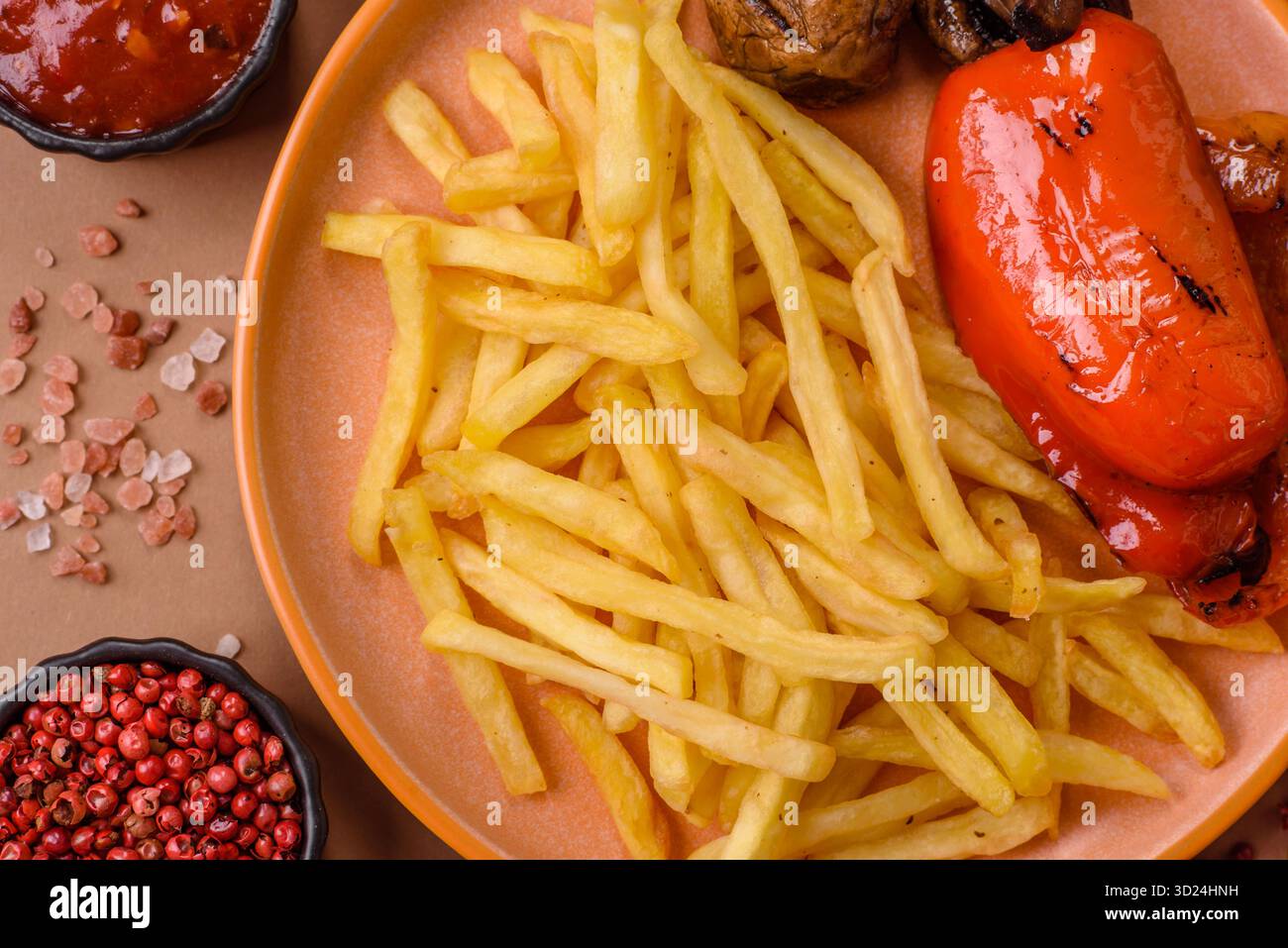 French fries cooked in oil, crispy golden chips, unhealthy food. French fries as a background Stock Photo