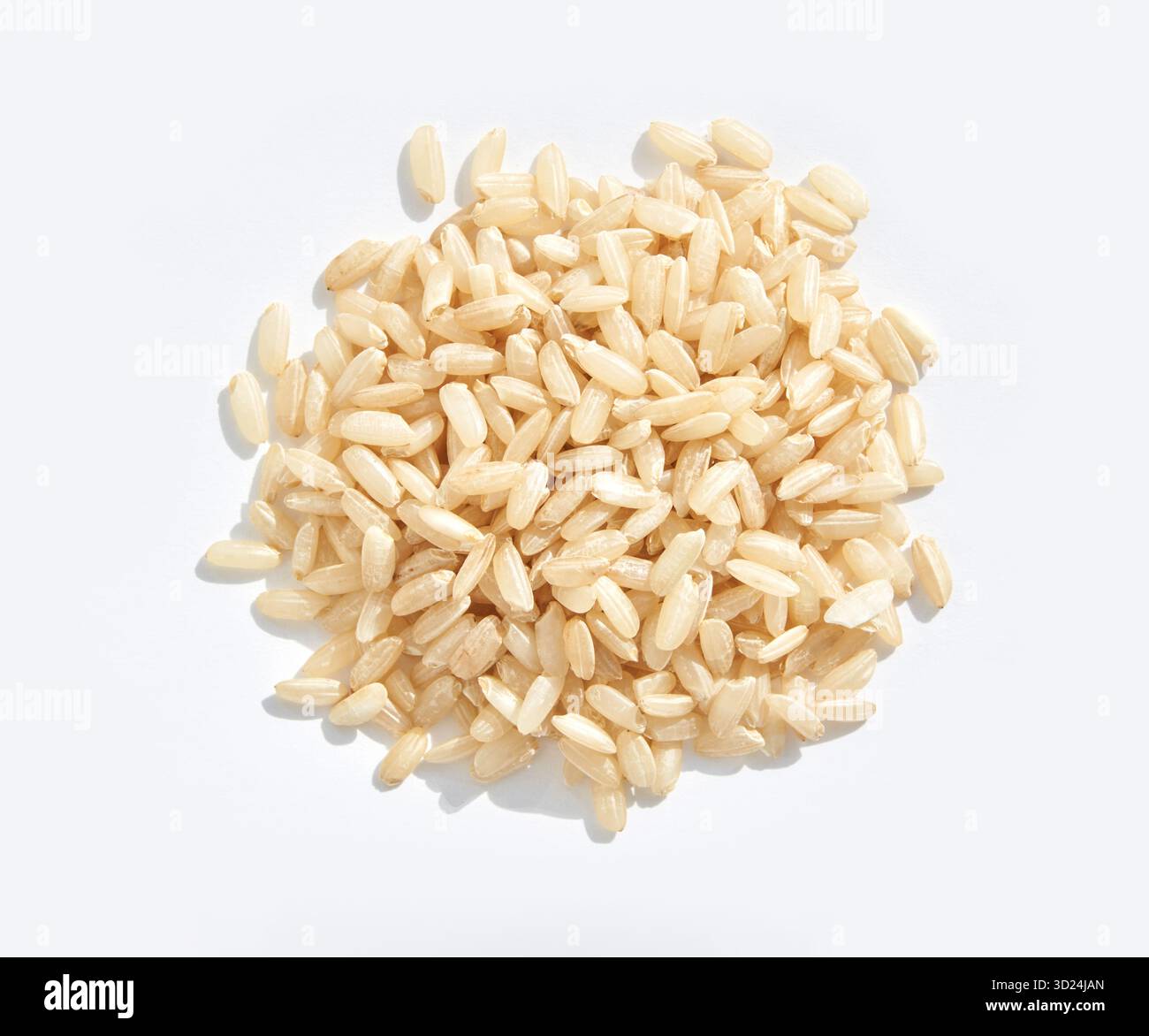 Close-up of uncooked brown rice grains on a white background Stock Photo