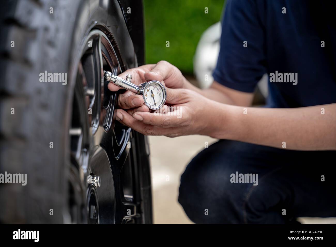 Close-up of a tire pressure gauge checking the air pressure of a car ...