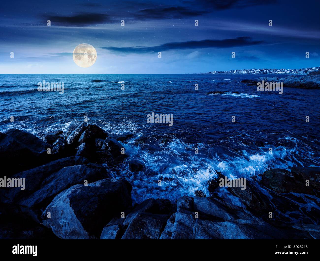 night landscape of rocky sea coast. beautiful full moon over horizon. summer coastline scenic view. composite scene during midnight. magical seascape Stock Photo