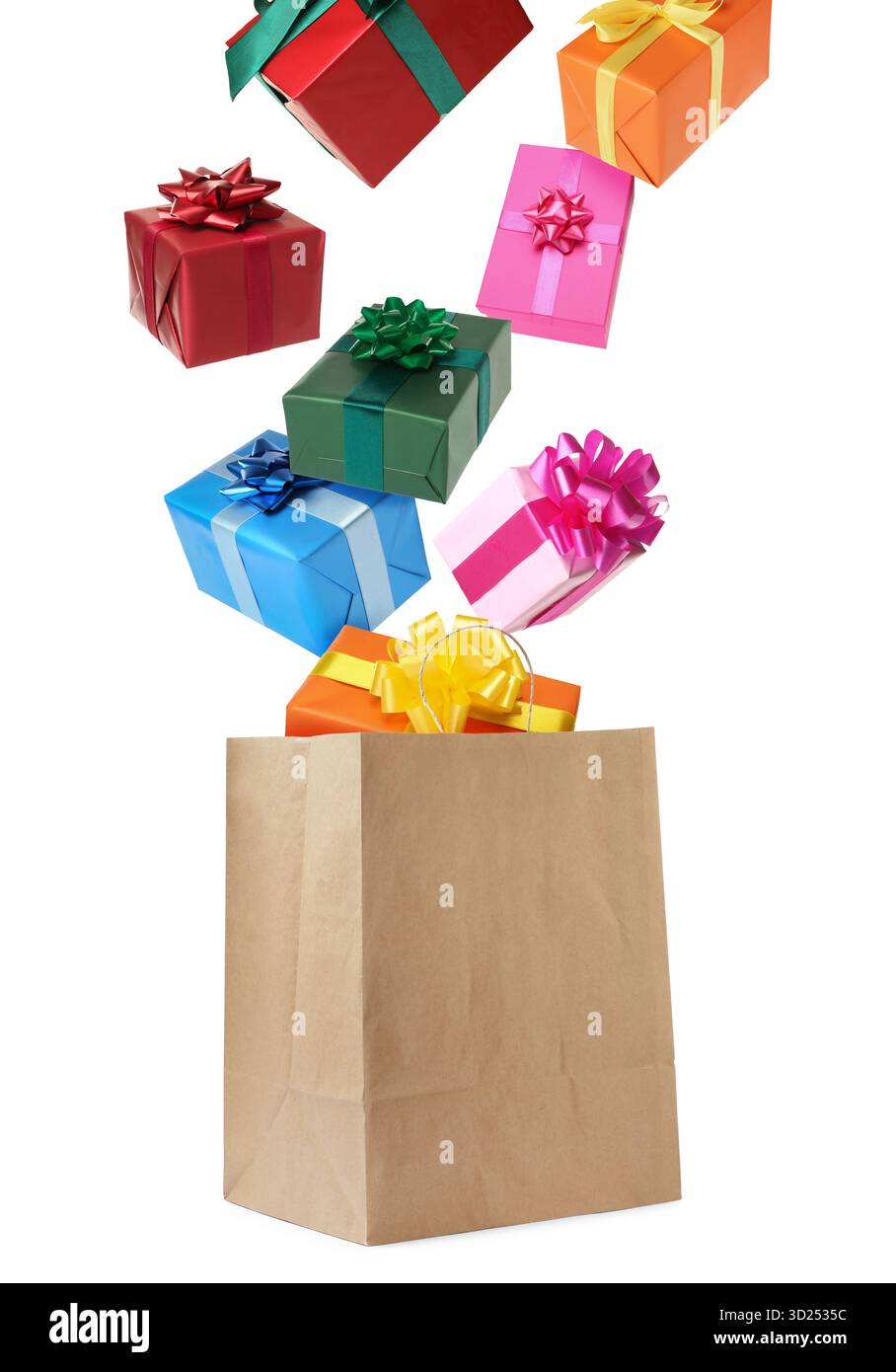 Many gift boxes falling into paper bag on white background Stock Photo