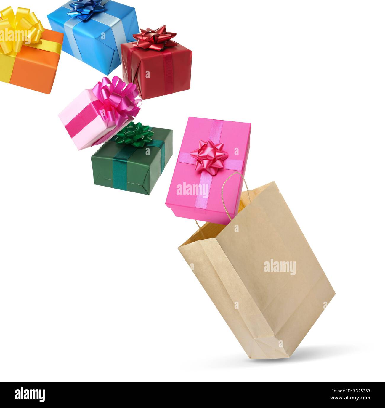 Many gift boxes falling into paper bag on white background Stock Photo