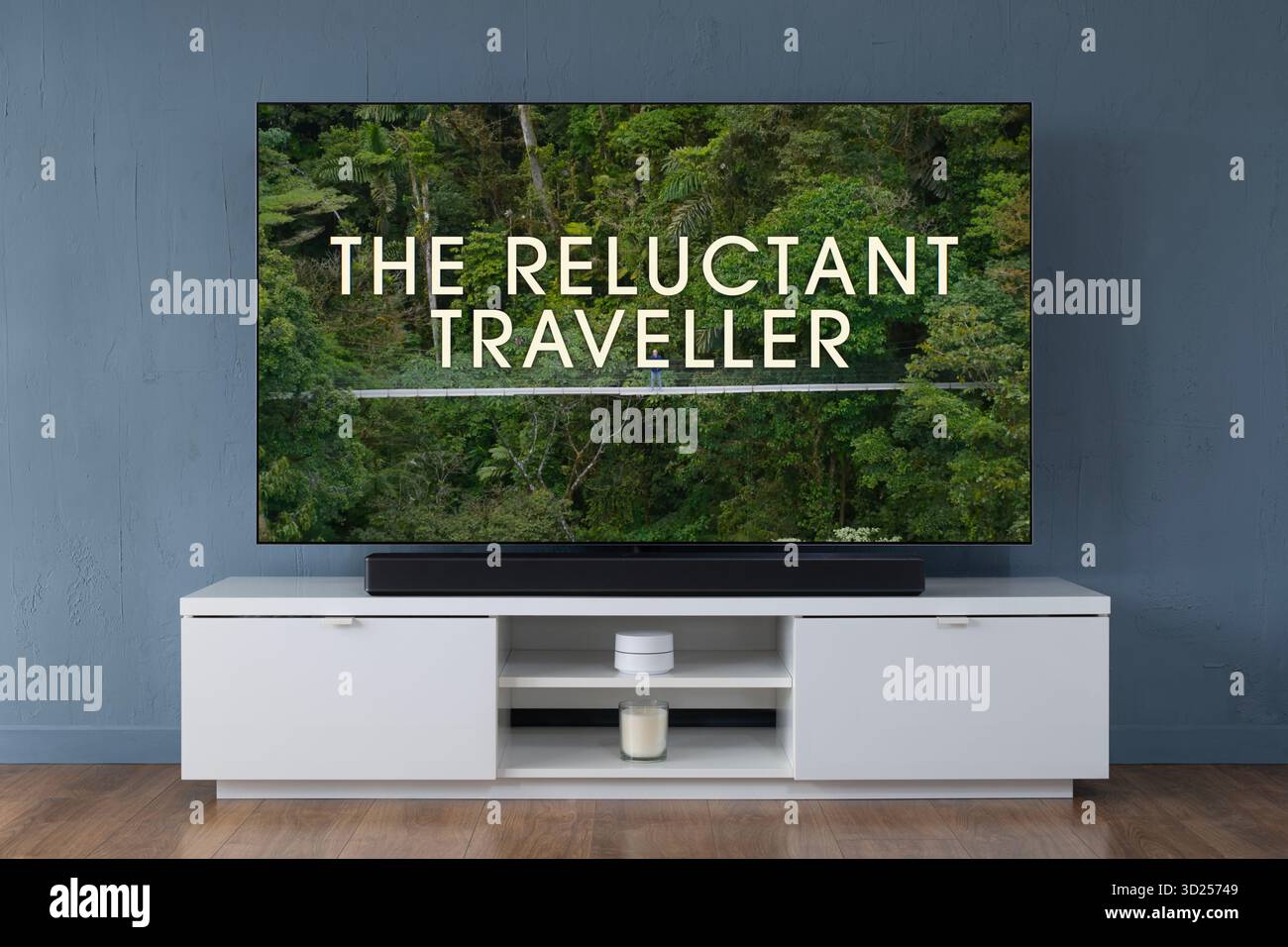 A widescreen OLED television showing the intro scene to the TV series The Reluctant Traveller, seen in a contemporary living room. Stock Photo