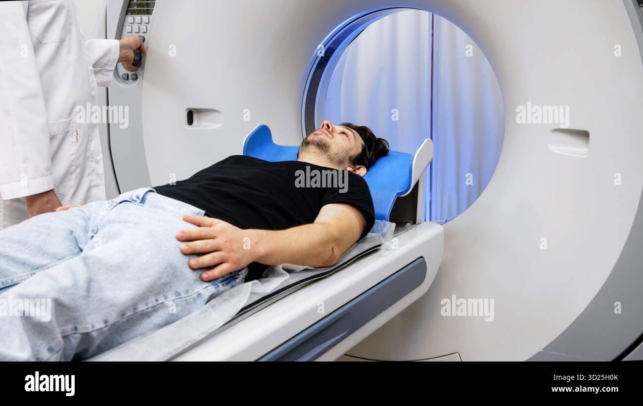Individual positioned on CT scanner table, ready for tomography, with ...