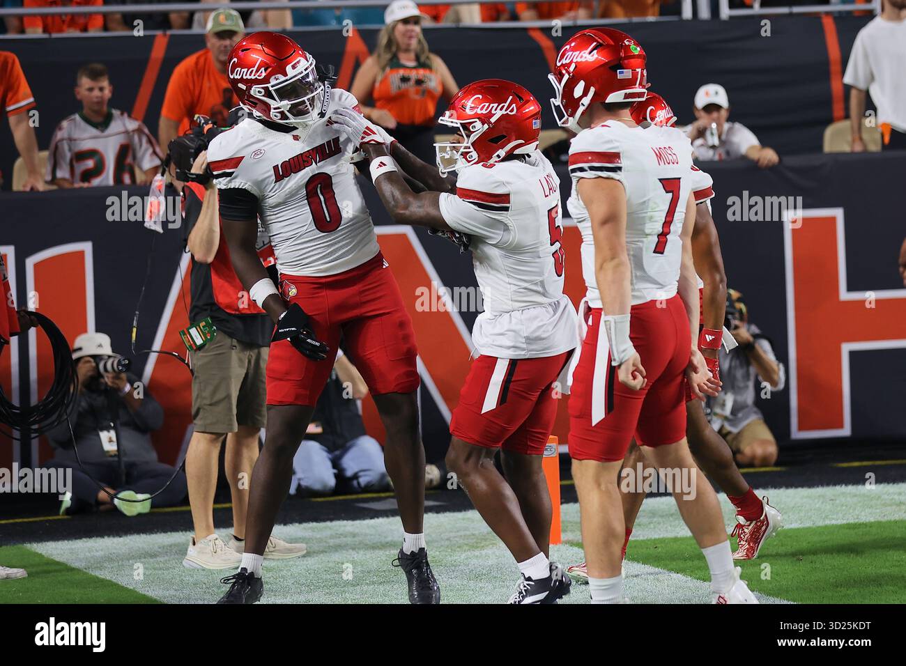 Louisville Cardinals wide receiver Chris Bell (0) celebrates his touchdown with teammates at Hard Rock Stadium on October 17, 2025 in Miami Gardens, F Stock Photo