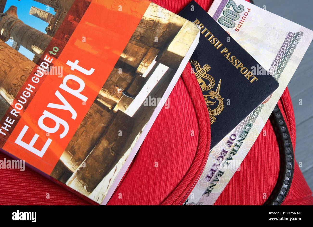 Egypt travel guide book with british passport and Egyptian currency Stock Photo