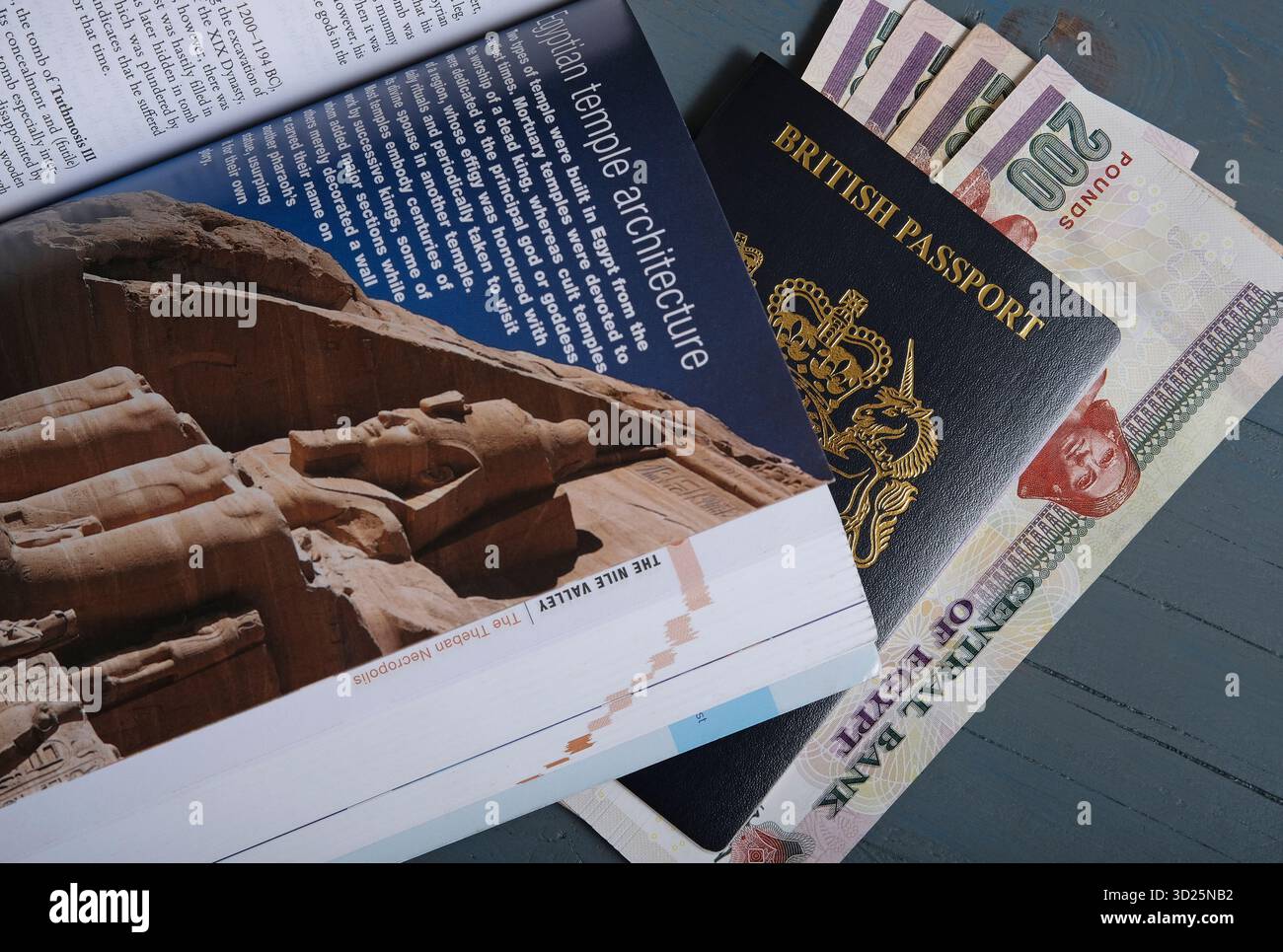 Egypt travel guide book with british passport and Egyptian currency Stock Photo