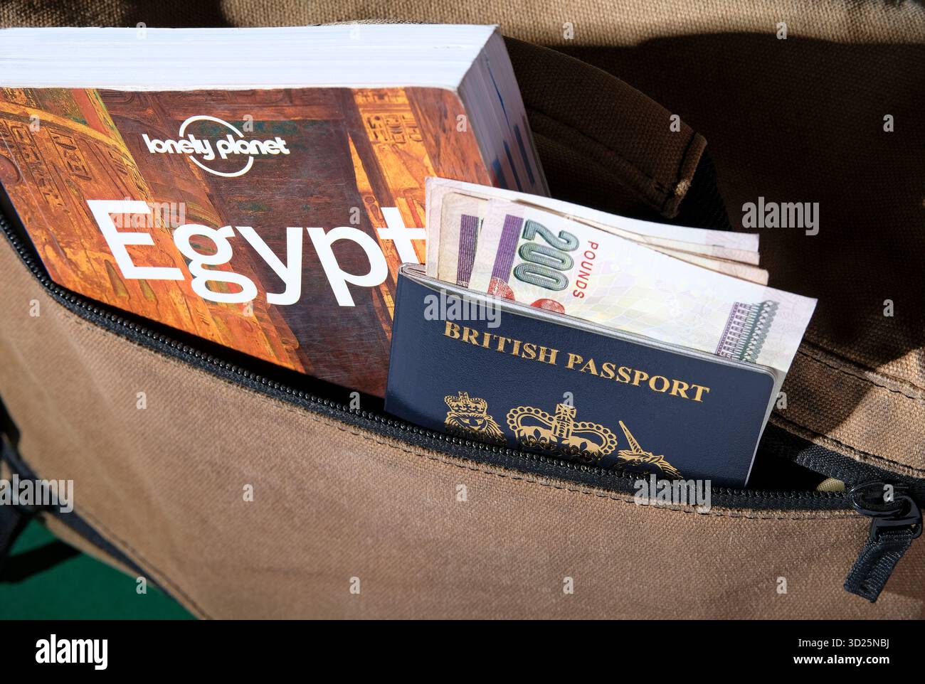 Egypt travel guide book with british passport and Egyptian currency Stock Photo