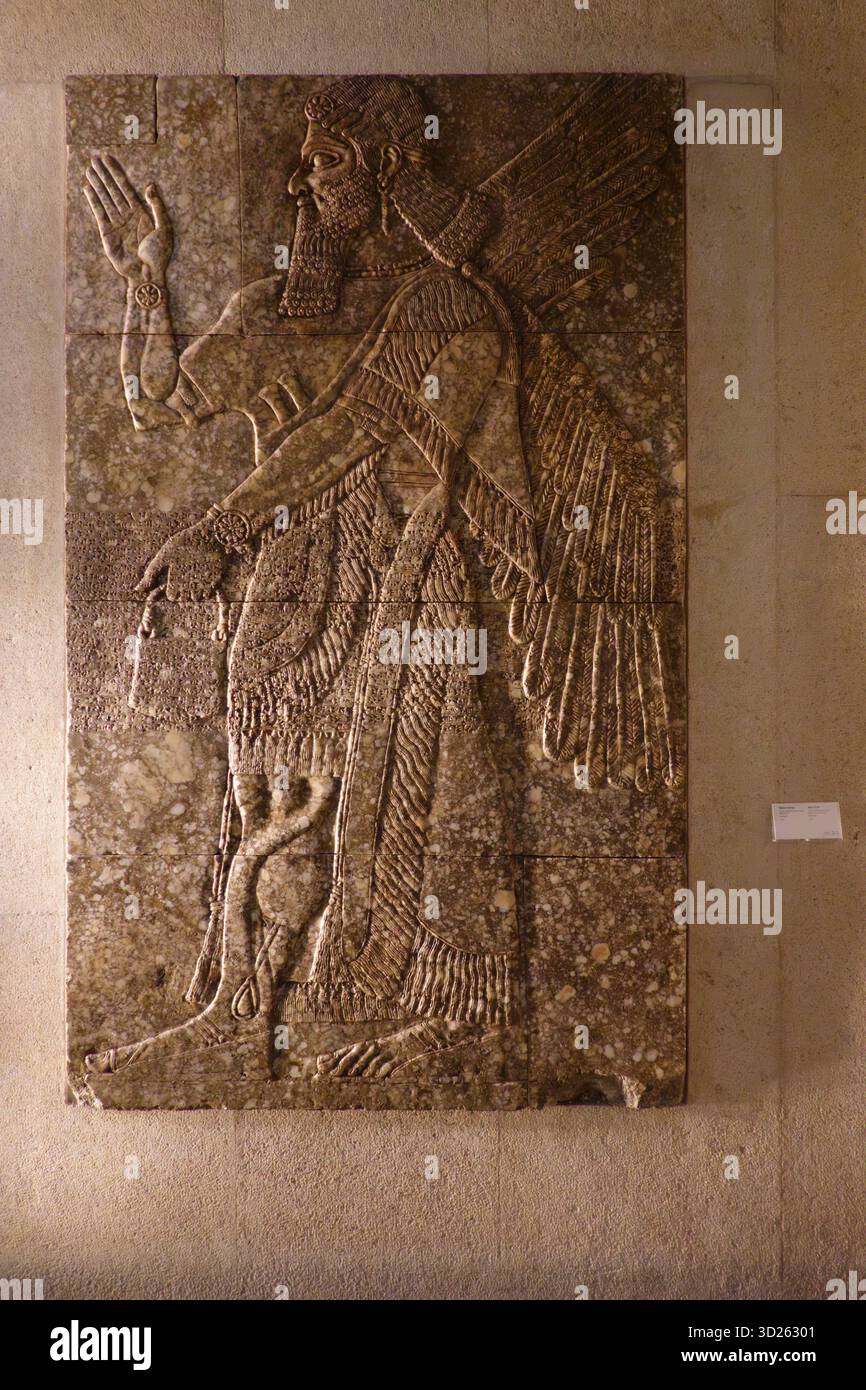9th Century BC relief of an Assyrian winged genie from the reign of king Ashurnasirpal II at the Calouste Gulbenkian Museum in Lisbon, Portugal Stock Photo