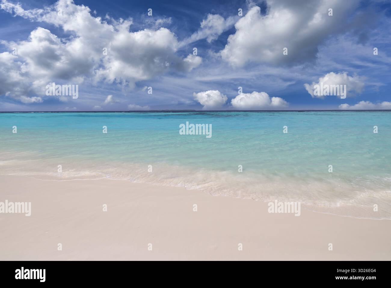 Sunny beach landscape with calm waves tranquil horizon cloudy happy sky creating peaceful coastal nature background Stock Photo