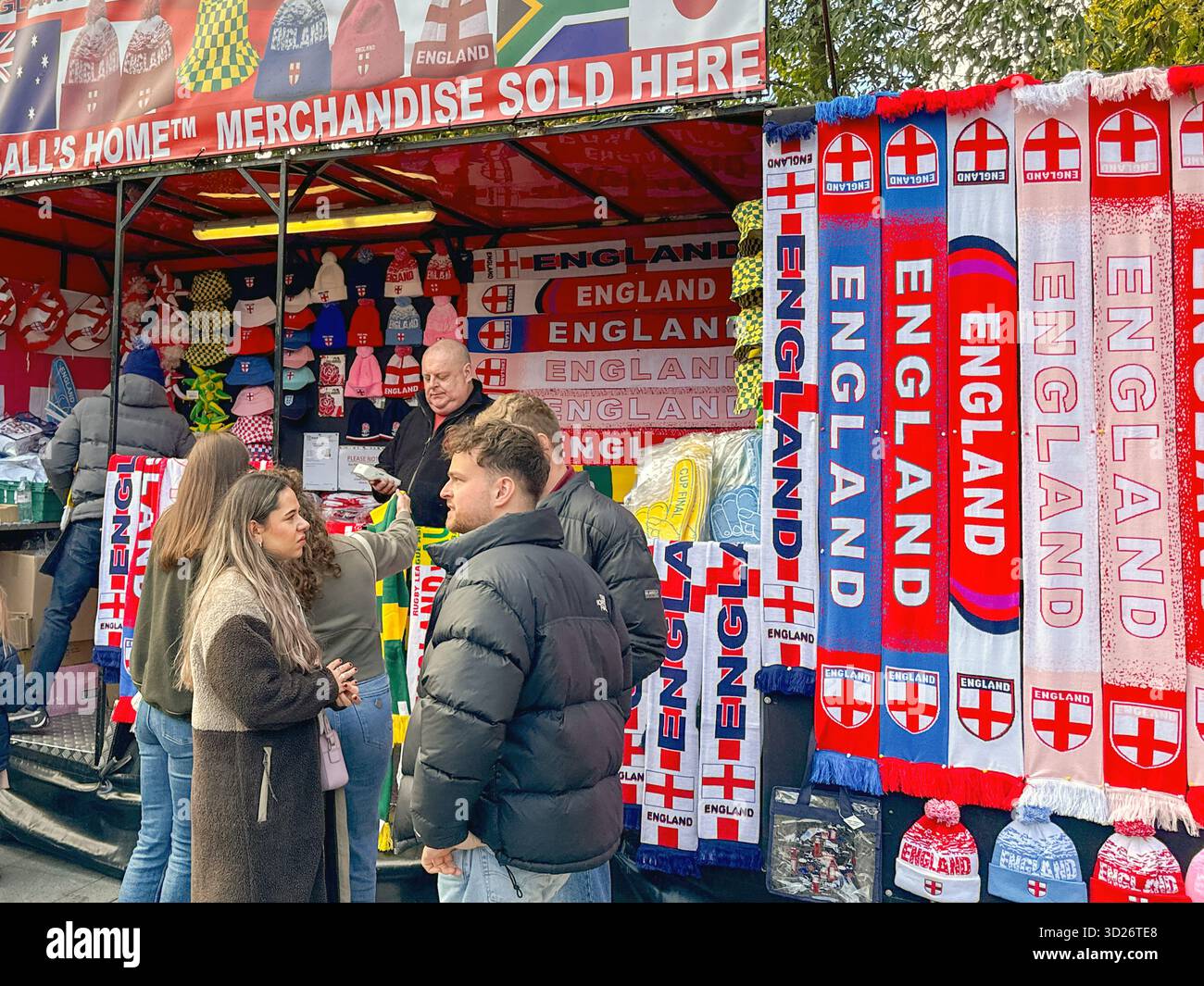 London, England, Uk - 25 October 2025: Sports fans at a souvenir stand selling scarves and hats outside Wembley stadium for a rugby match - Smartphone Captured Stock Image