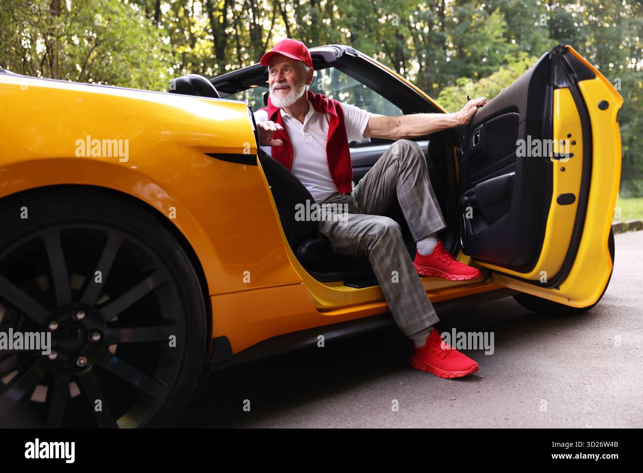 Stylish senior man getting out of modern cabriolet outdoors Stock Photo