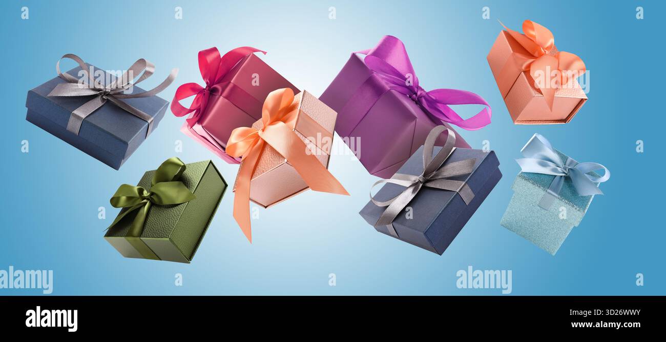 Gift boxes flying in air on blue gradient background Stock Photo