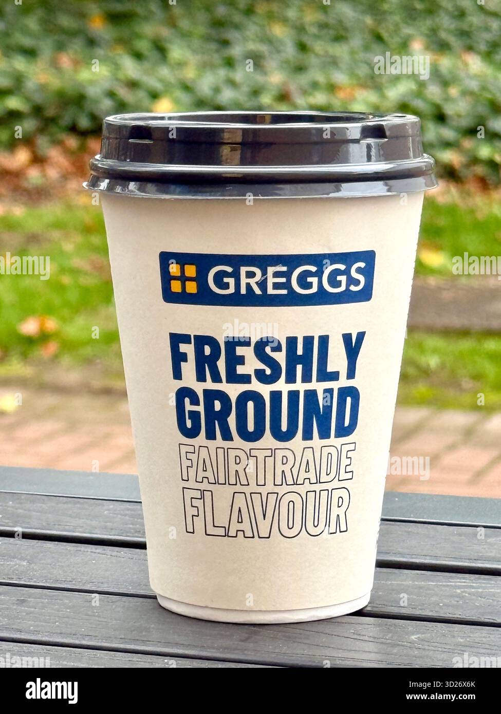 Cardiff, Wales, UK - 17 October 2025: Greggs Fairtrade coffee in a disposable paper cup with a plastic lid. No people. - Smartphone Captured Stock Image