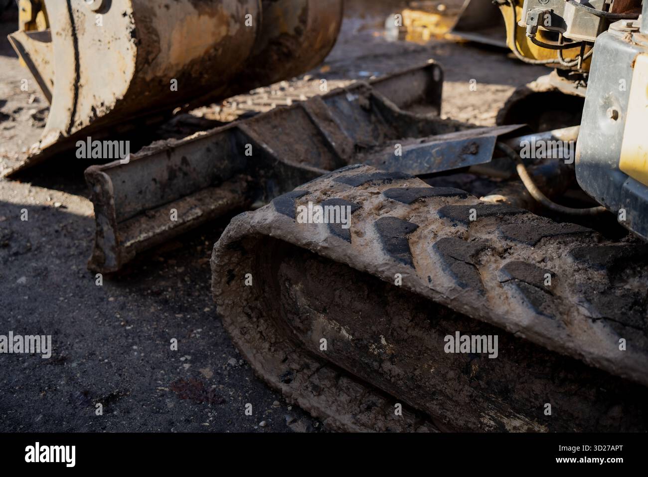 Detailed view of rubber track and steel blade of compact excavator ...